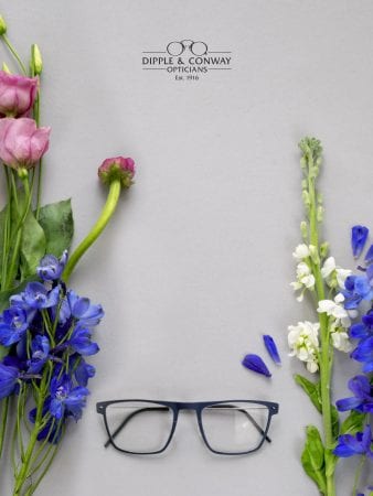 glasses with flowers in background