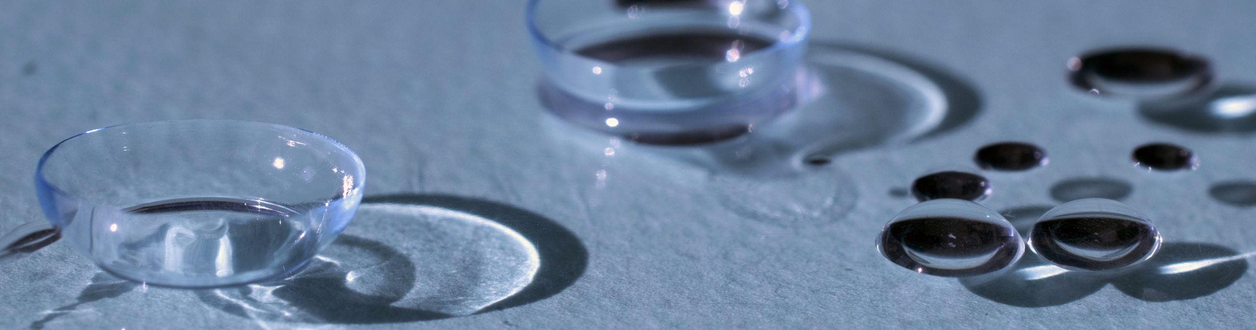 Optician putting contact lens in patient's eye