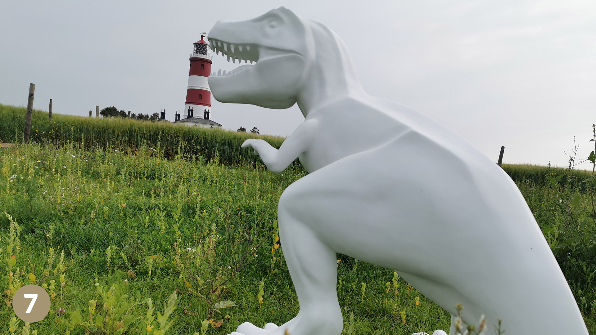 dinosaur near light house