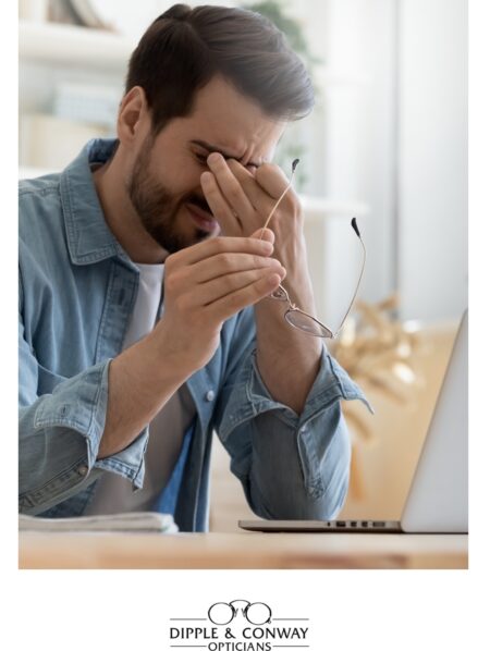 Man with a headache holding his face
